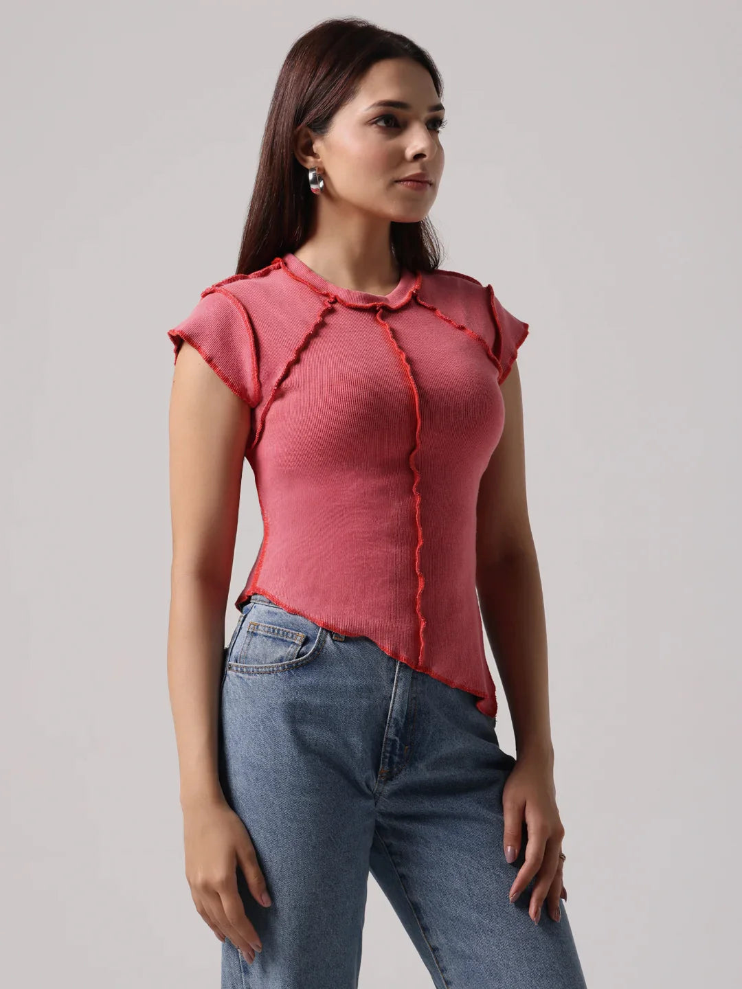Rose-pink top with cap sleeves and exposed front stitching detail