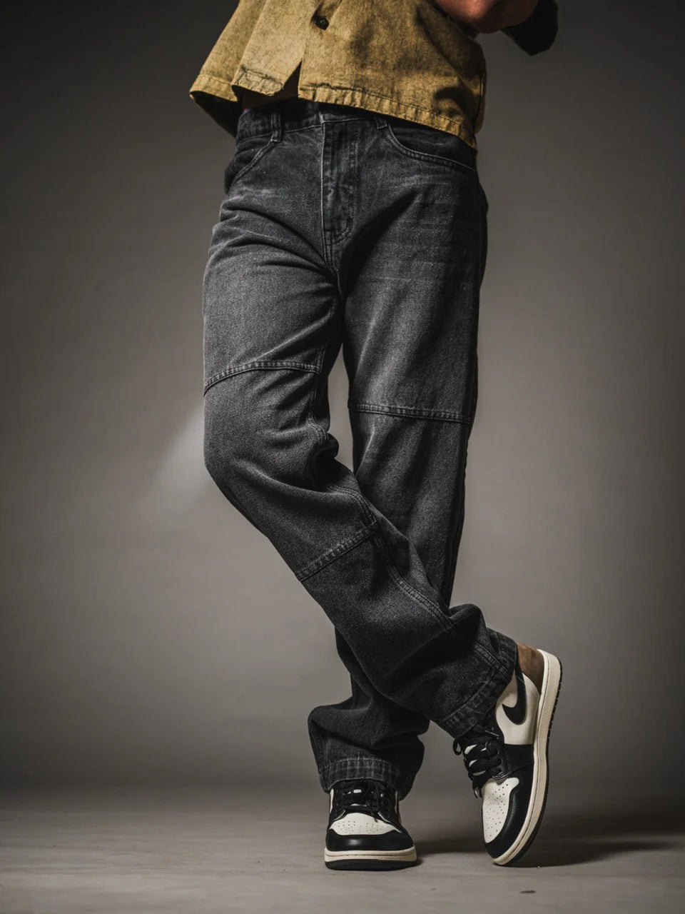 Loose fit dark gray jeans with knee panel stitching and relaxed leg