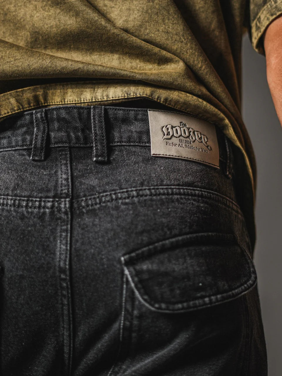 Bossini label on dark gray loose jeans with front pocket and panel stitching