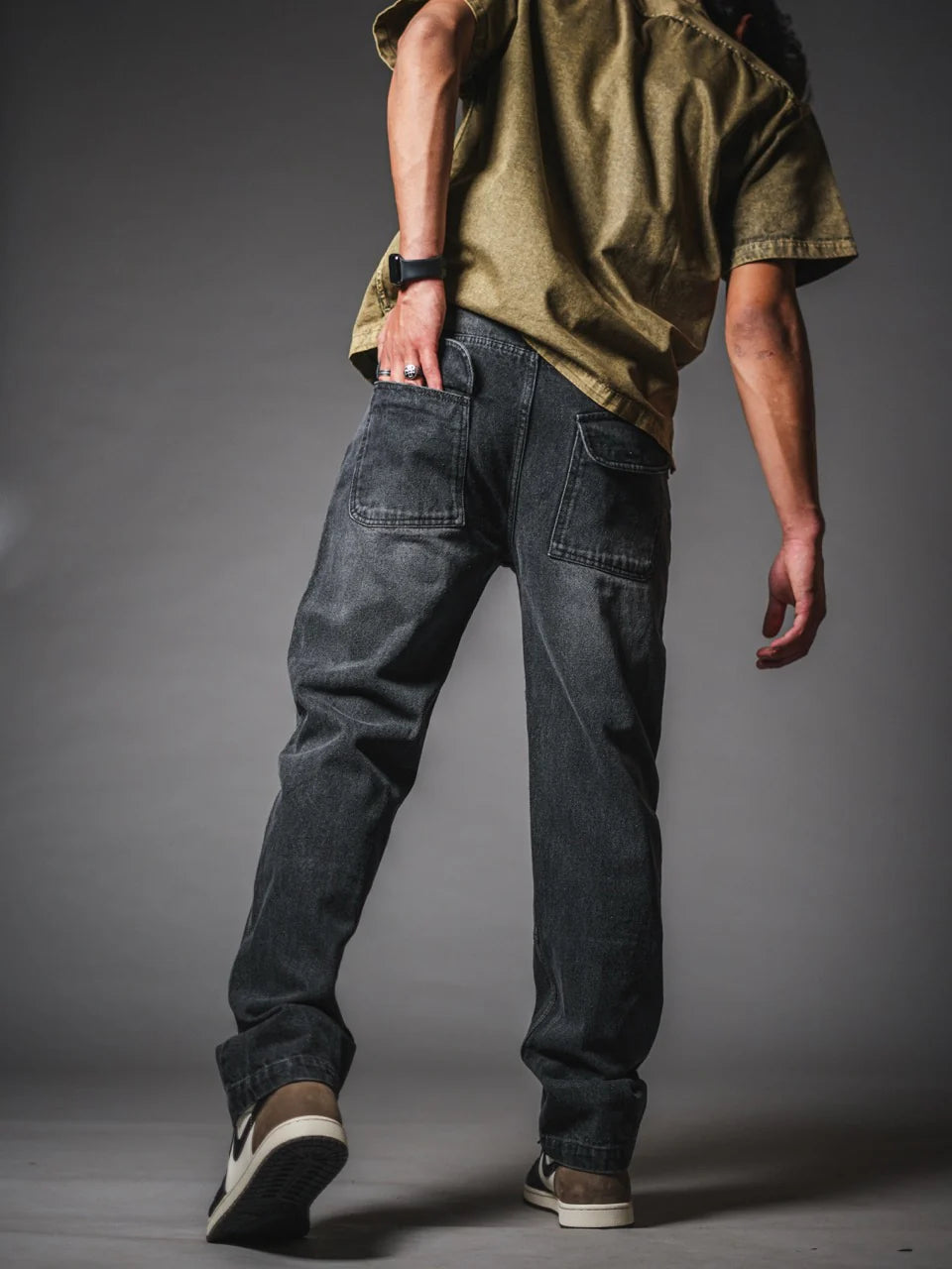 Loose fit dark gray jeans with knee panel patches and roomy leg