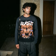Black long-sleeve crewneck sweatshirt with colorful front graphic and dark pants
