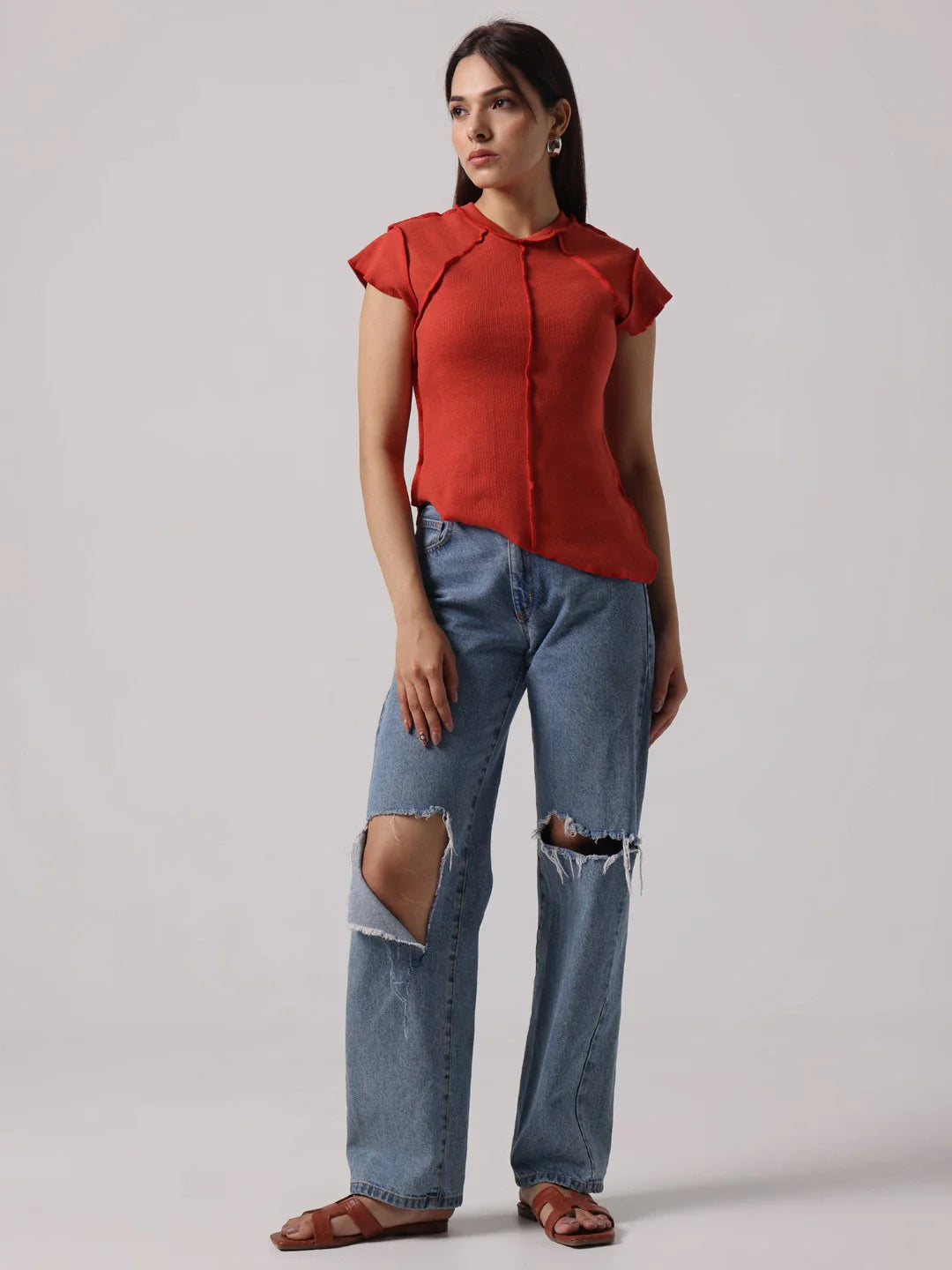 Red cap-sleeve top with exposed center-front seam and short structured sleeves