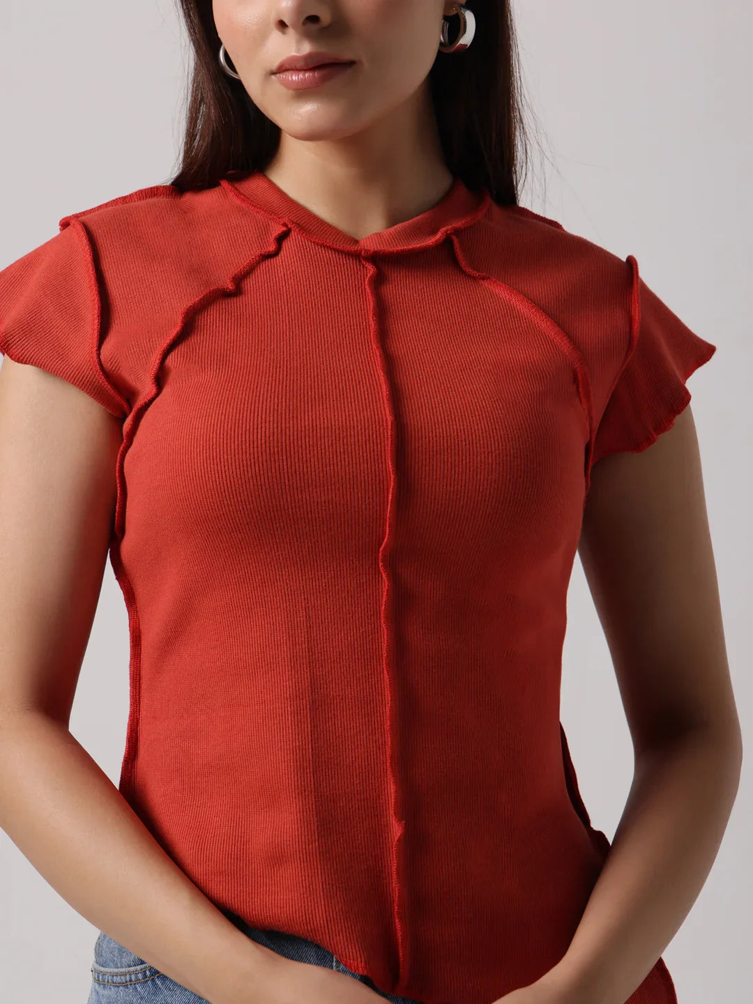 Red cap-sleeve top with stand collar and exposed center-front seam stitching