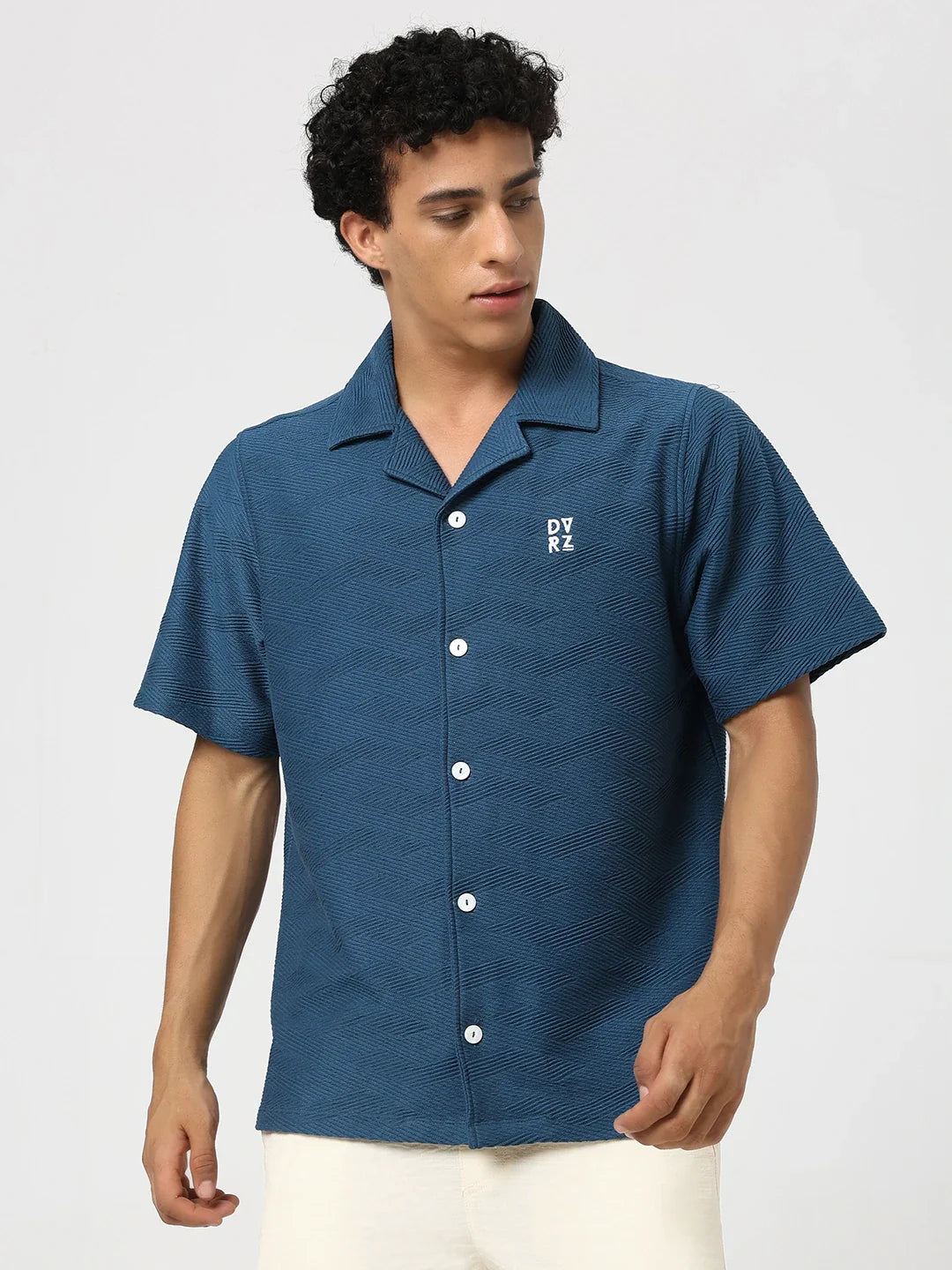 Blue textured bowling shirt with short sleeves, pointed collar, button front, chest logo