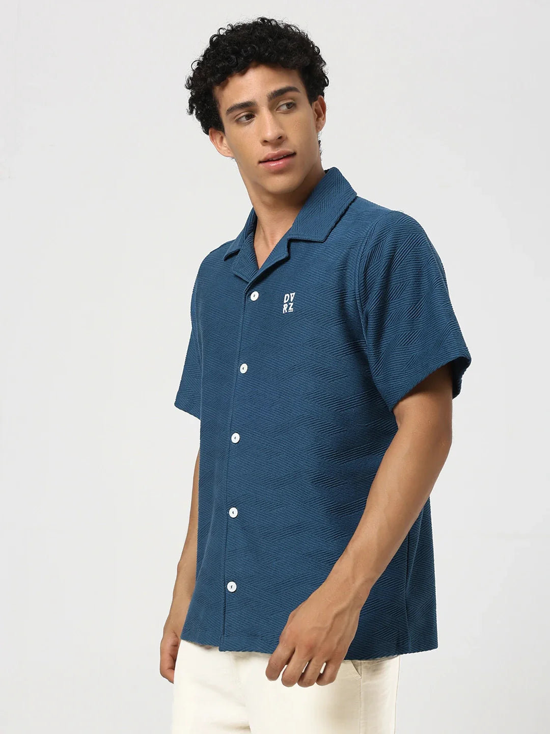 Blue textured bowling shirt with pointed collar, short sleeves, button front, chest logo