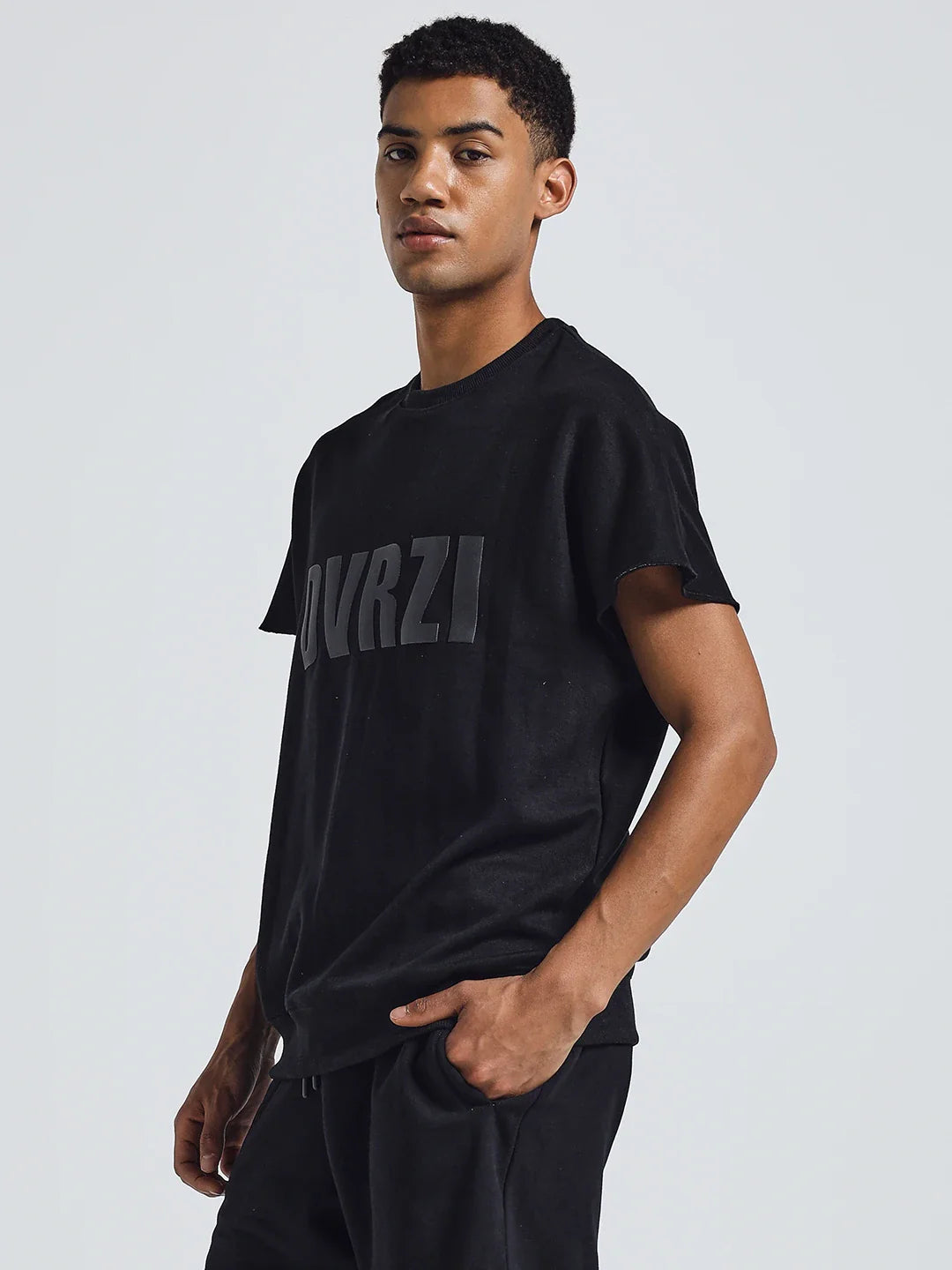 Black crew-neck T-shirt with DUVRZI logo, side view