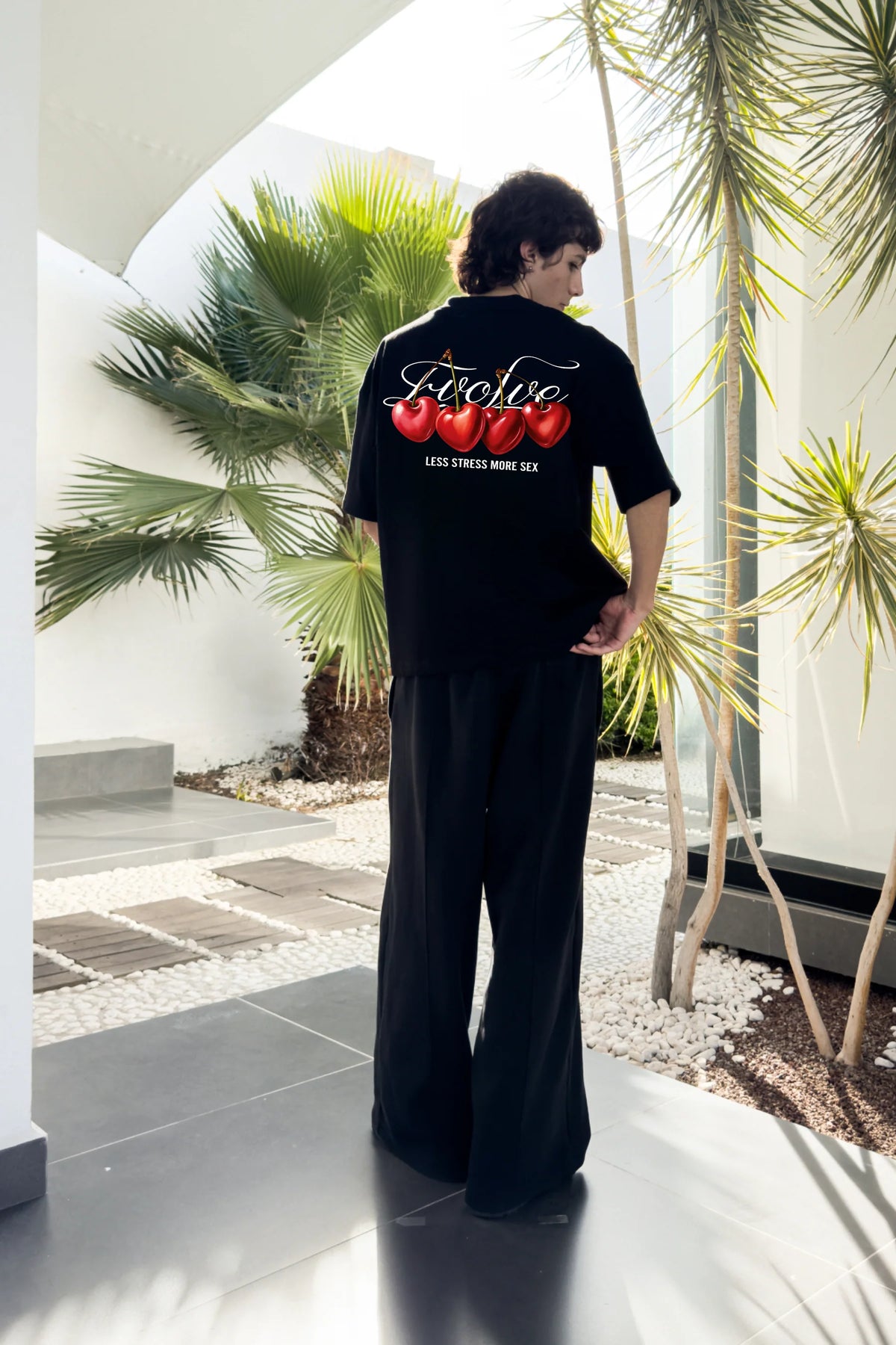 Black T-shirt with back cherry graphic and 'LESS STRESS MORE SEX' slogan