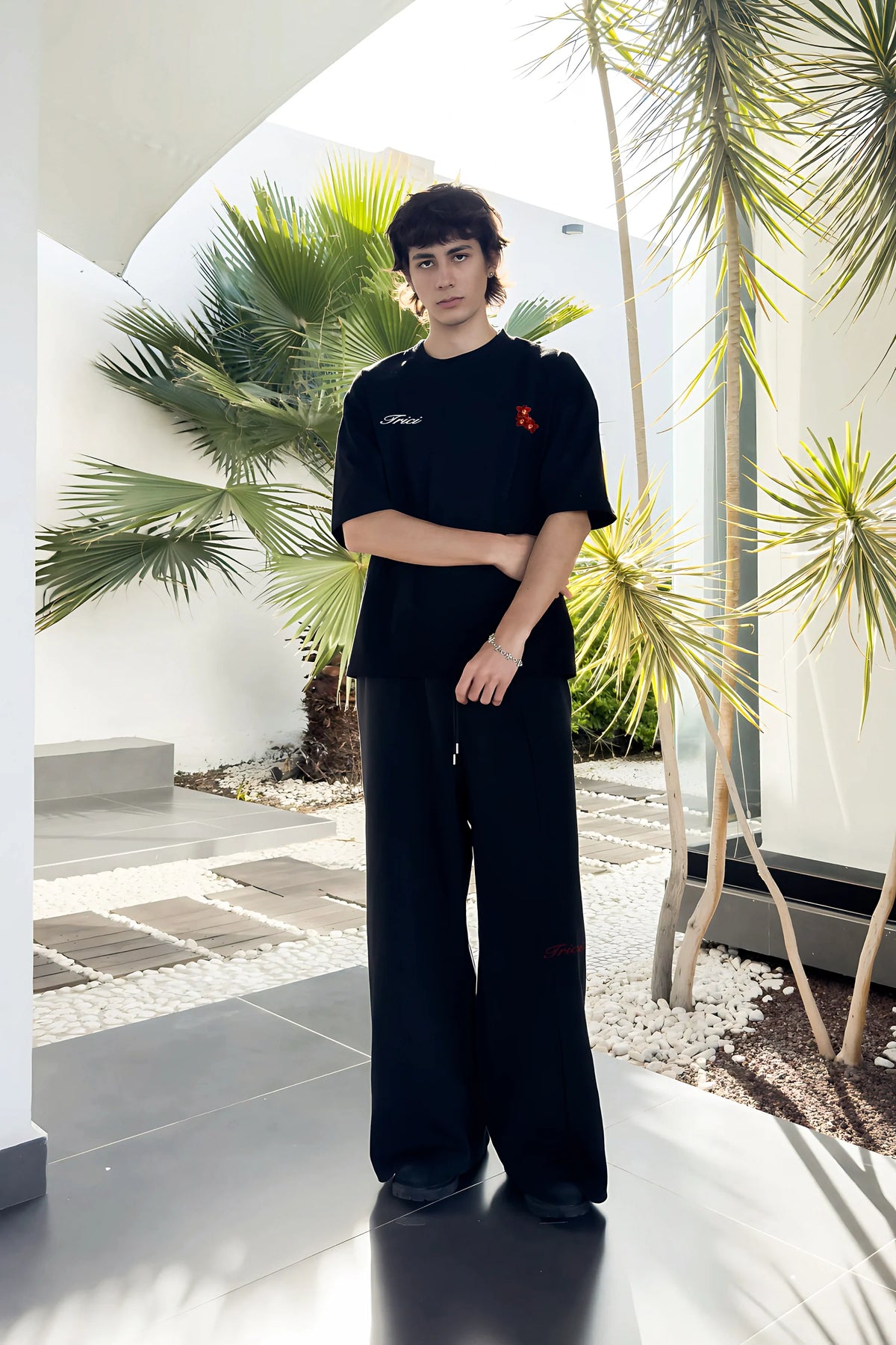 Black T-shirt front with small Trero logo and red cherry chest print