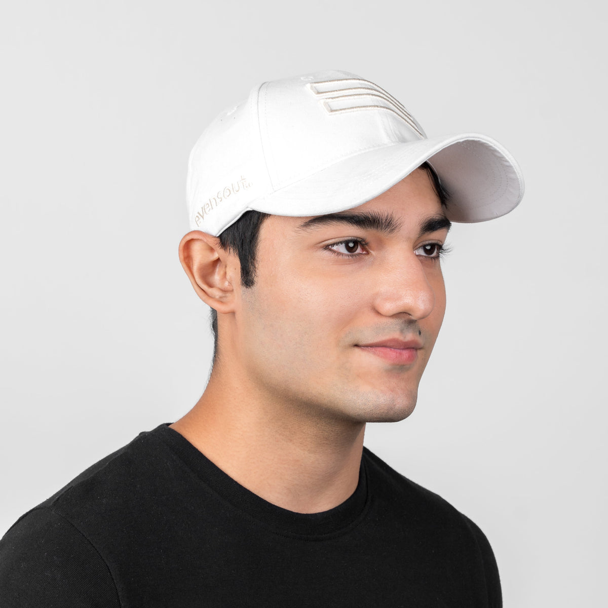 White baseball cap with curved brim and visible front logo patch
