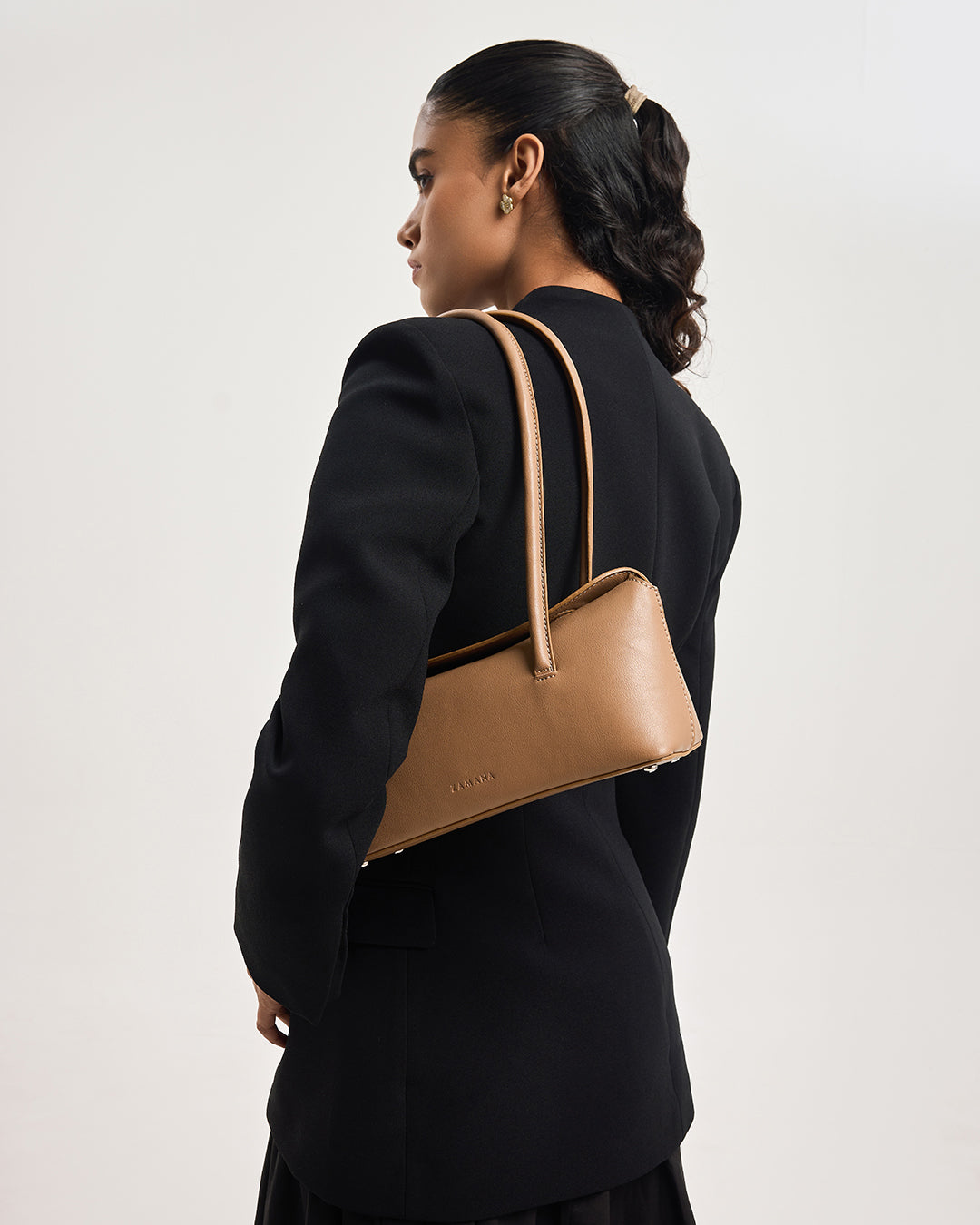 Caramel brown leather tote bag with top handle and adjustable shoulder strap