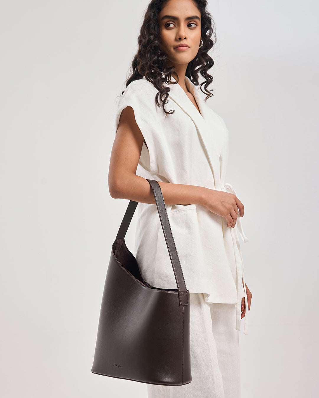 THE DECEMBER dark brown leather shoulder bag worn on shoulder