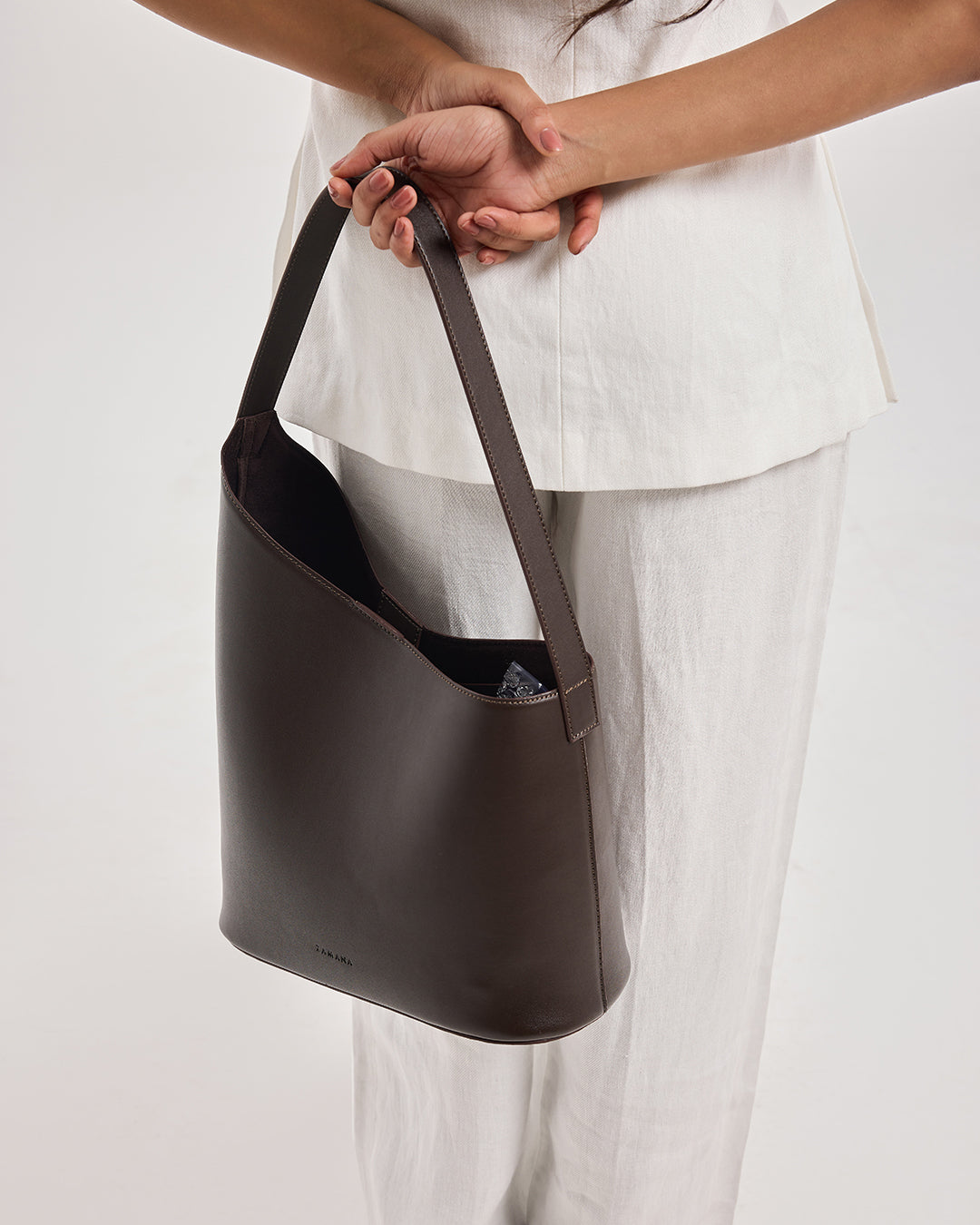 THE DECEMBER dark brown leather shoulder bag held by top handle