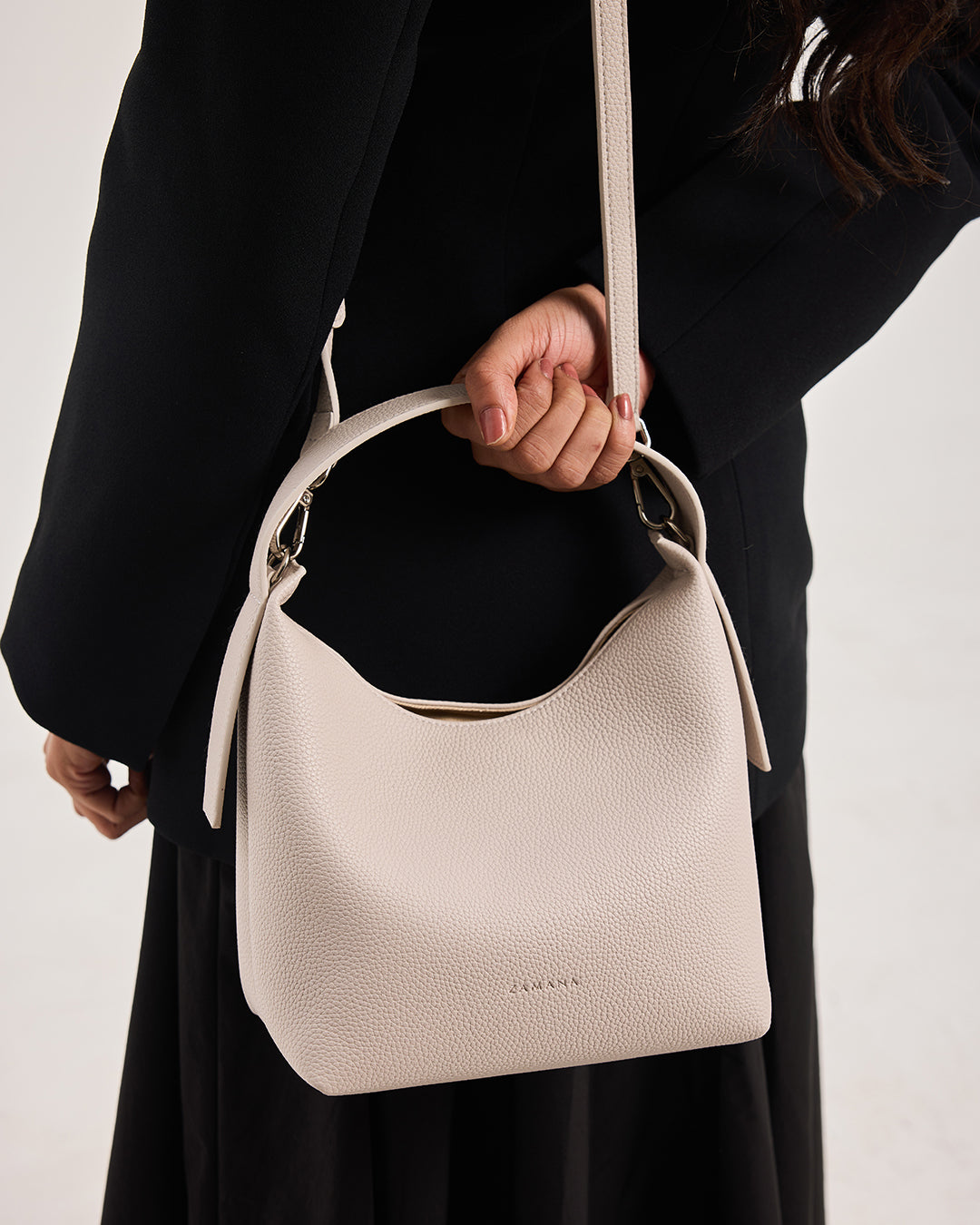 Cream textured hobo shoulder bag with top zip and adjustable strap