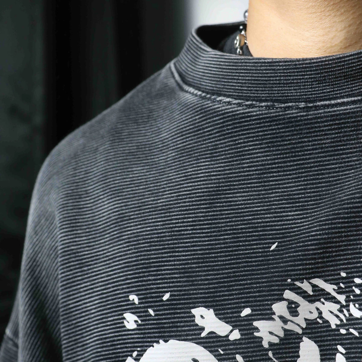 Ribbed crewneck collar and knit texture on charcoal long-sleeve sweatshirt