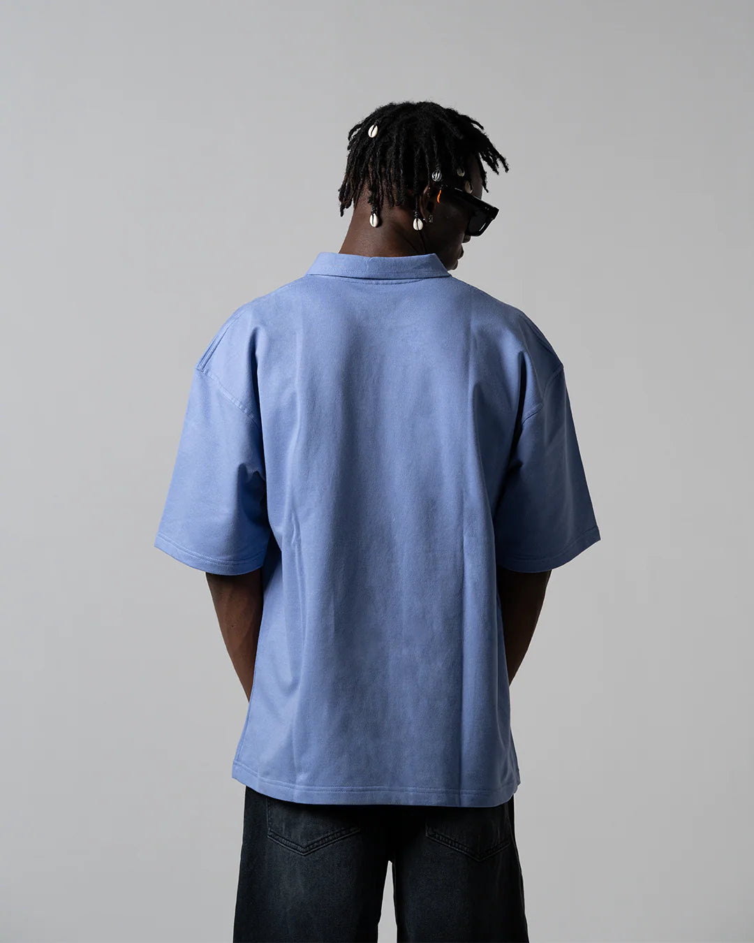 Light blue polo shirt with short sleeves, plain back view.