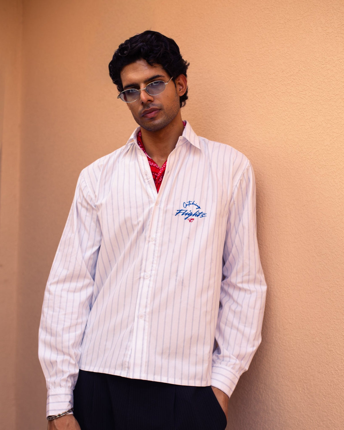 White pinstripe suiting shirt with blue stripes, chest script logo, red collar lining