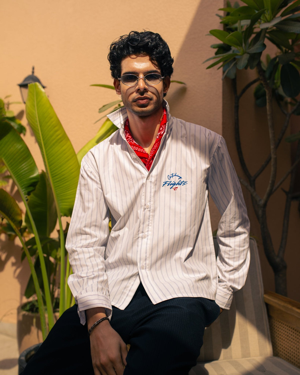 White pinstripe suiting shirt with blue stripes and embroidered chest logo, buttoned