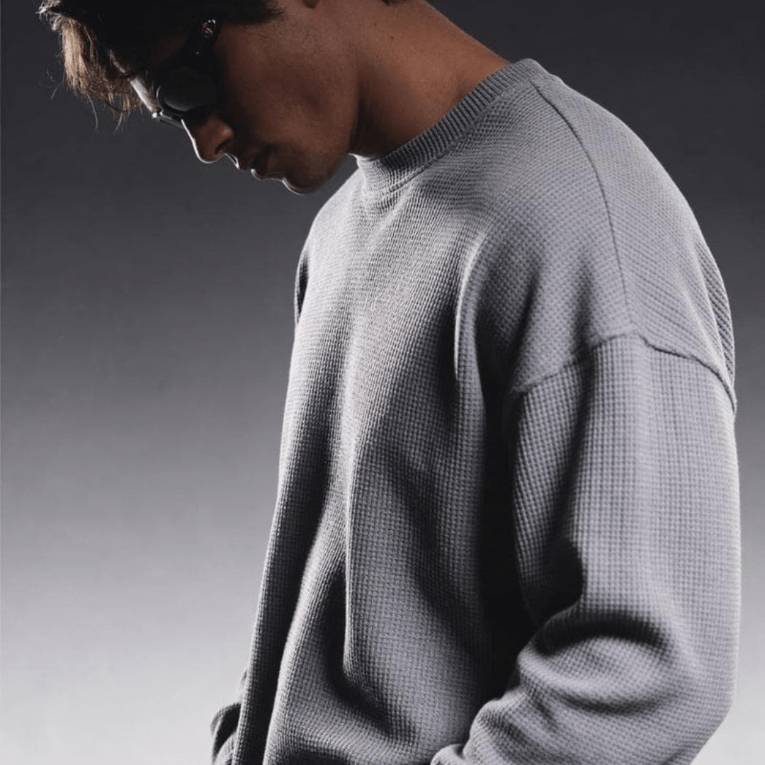 Grey waffle-knit crewneck long-sleeve sweater, side view
