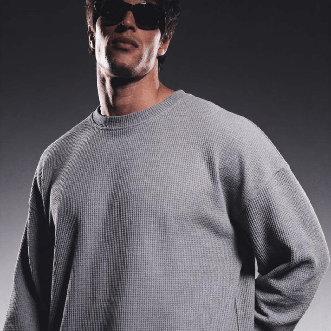 Grey waffle-knit crewneck long-sleeve sweater with ribbed collar