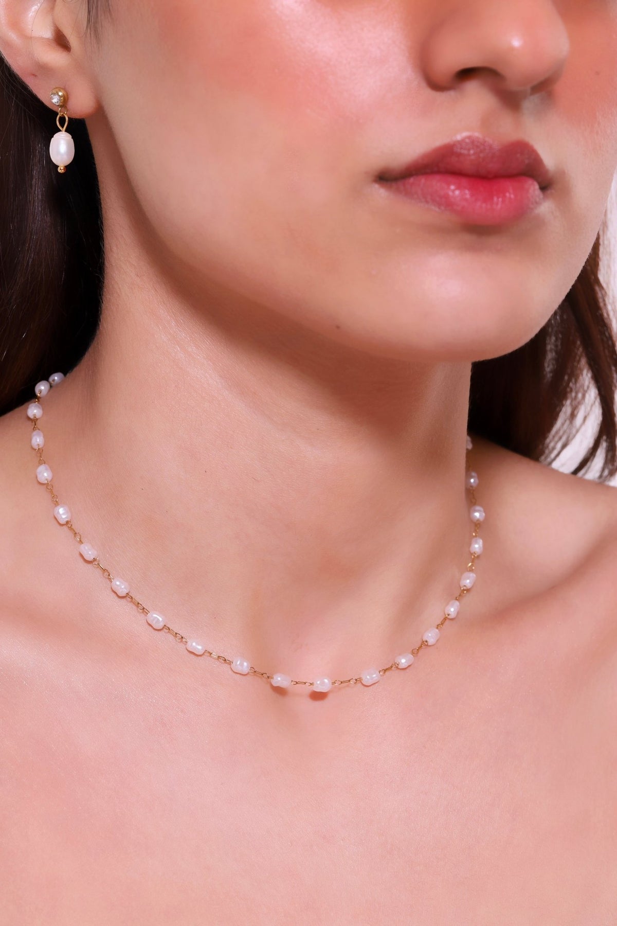 Iridescent pearl necklace on gold-tone chain with light purple round beads