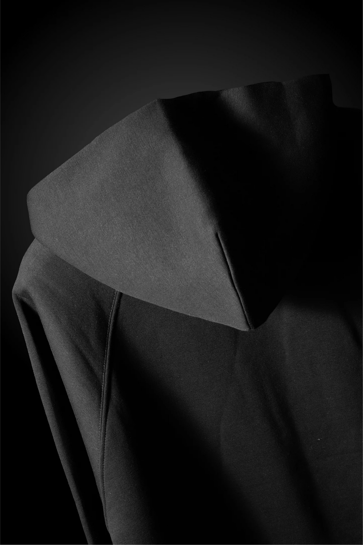 Charcoal black hoodie hood with seam stitching, close-up