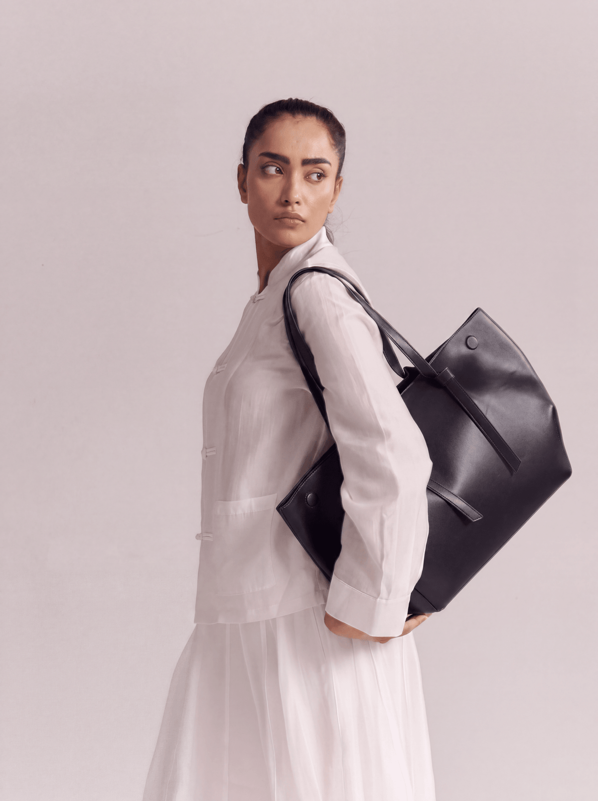 Large black tote bag with top handles and adjustable shoulder strap