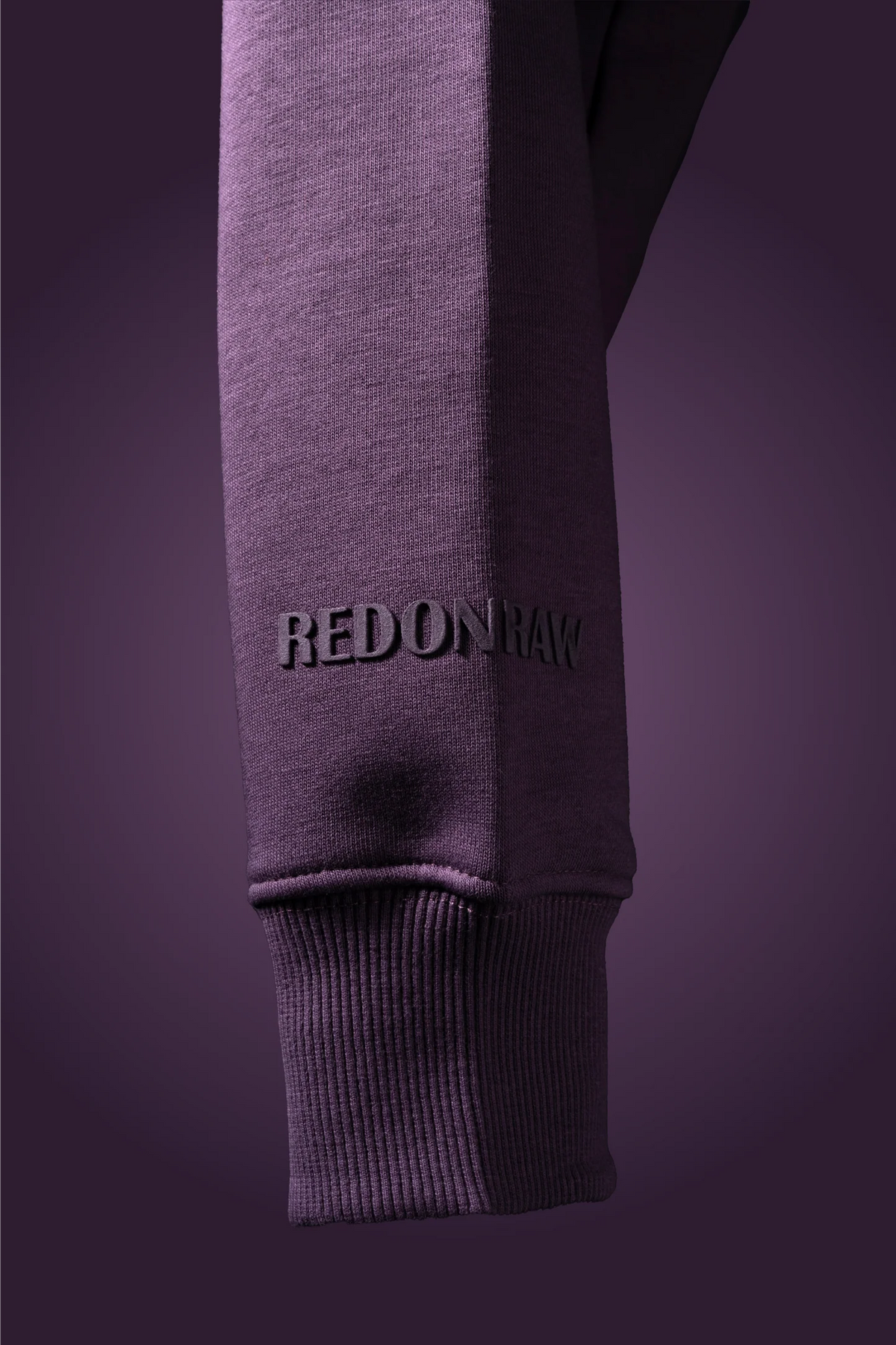 Lilac hoodie sleeve cuff with REDONRAW text on the forearm