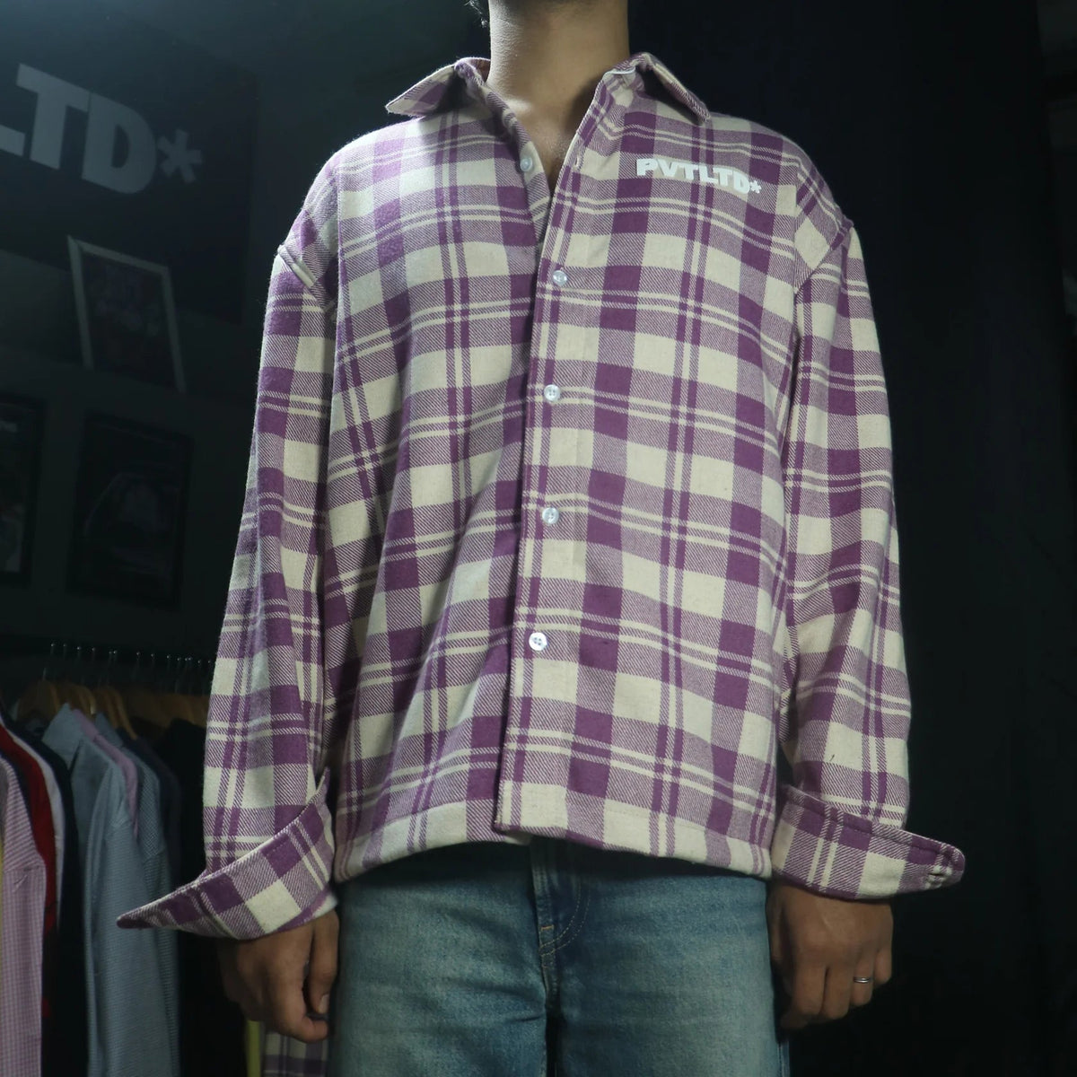 Plaid button-up shirt with long sleeves and chest logo patch