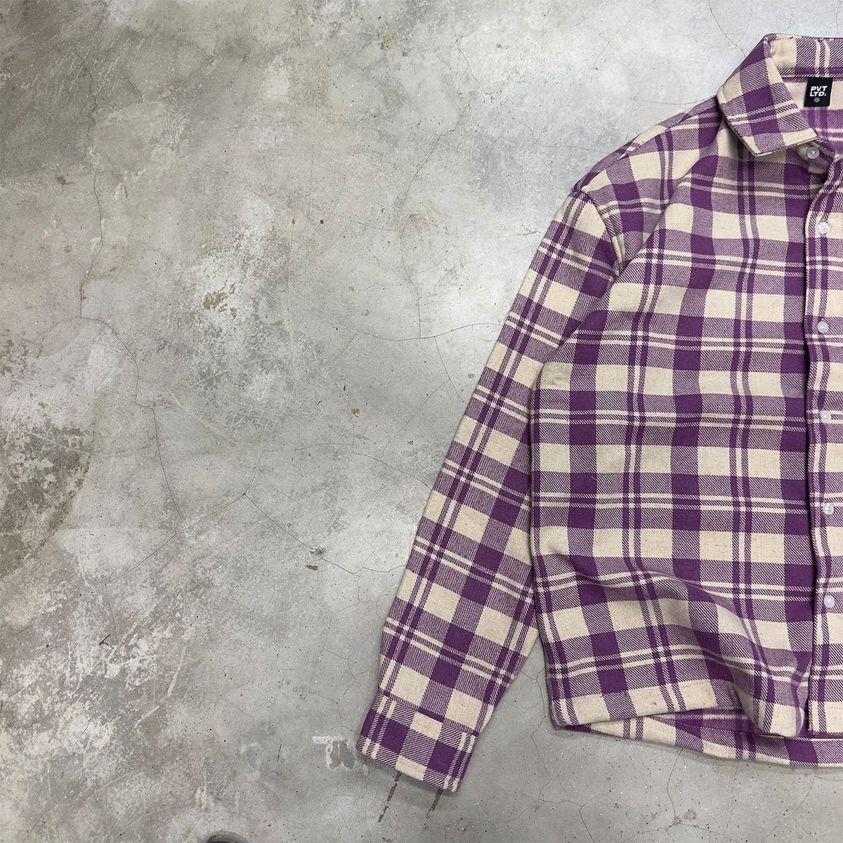 Plaid shirt with pocket detail and button-up front, shown at an angle