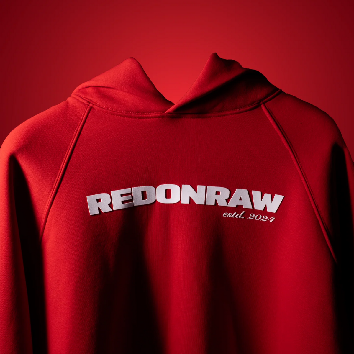 Blood red hoodie chest logo: REDONRAW est. 2024