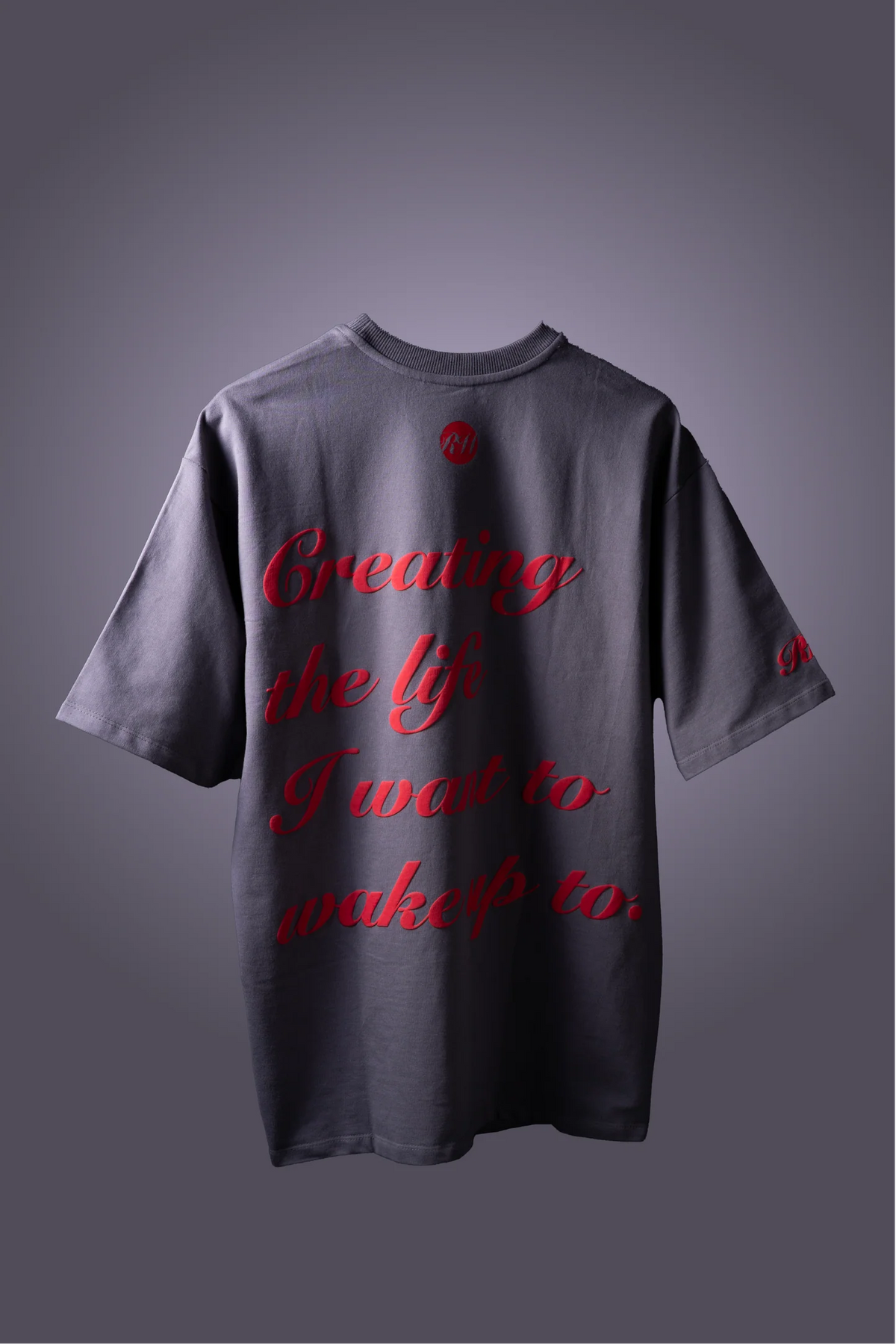 Gray T-shirt with red script 'Creating the life...' short sleeves and crew neck