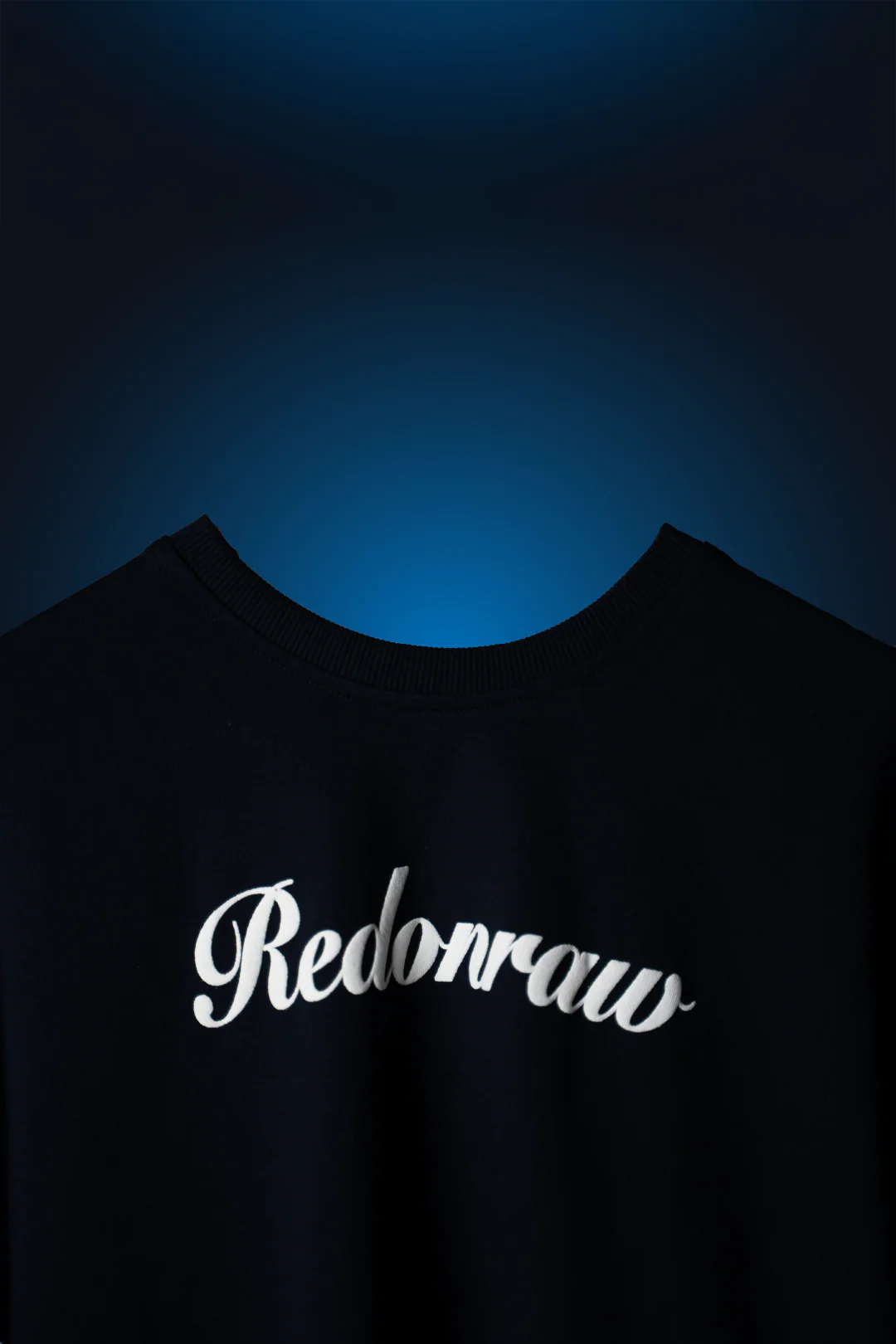 Navy blue crewneck T-shirt with 'Rednoraw' script graphic across the chest