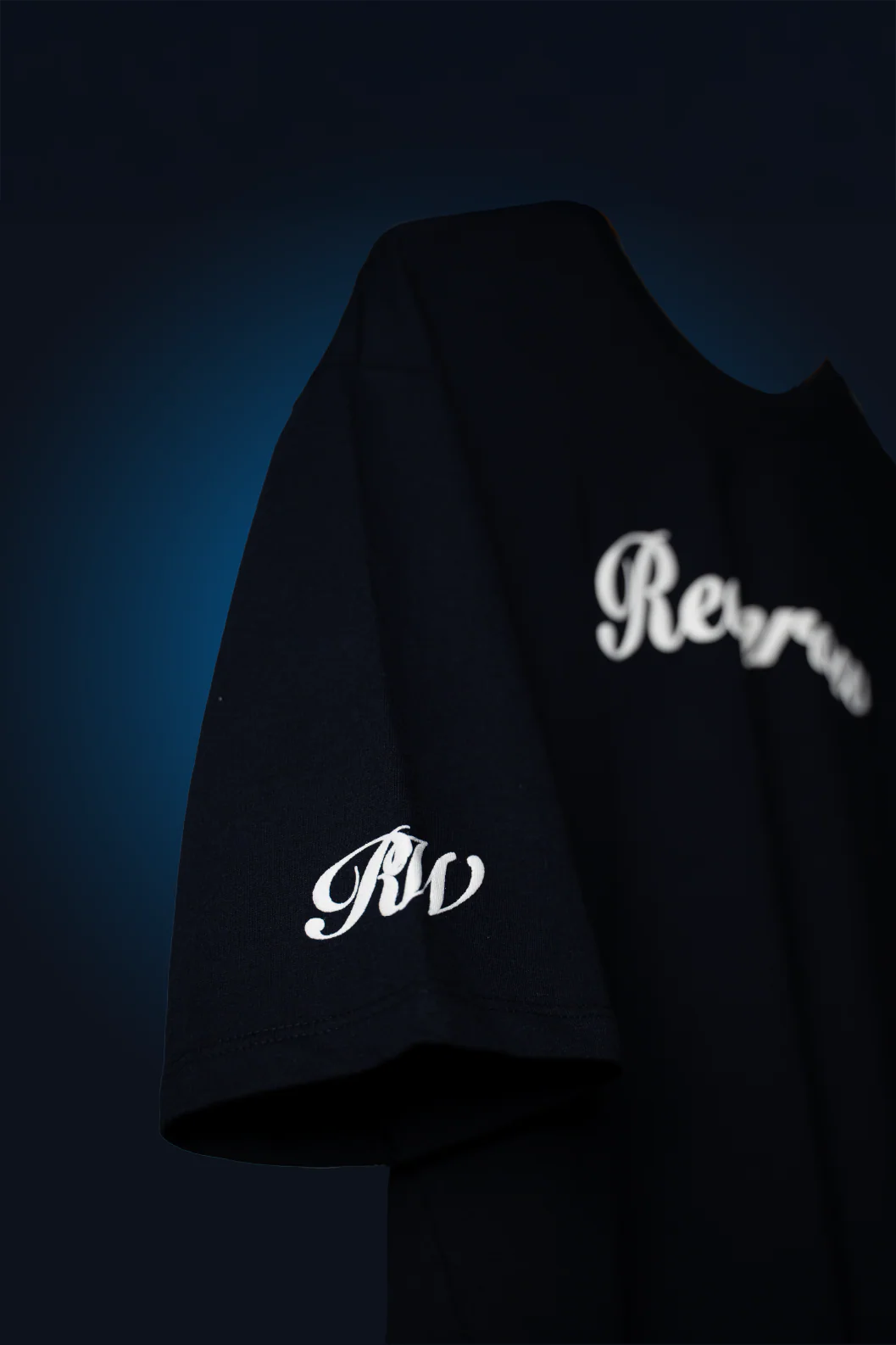 Navy blue crewneck T-shirt with partial white script and small RW emblem on chest