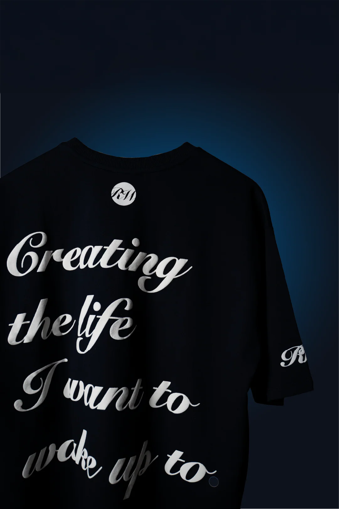 Navy blue graphic crewneck T-shirt with large 'Creating the life I want to...' text