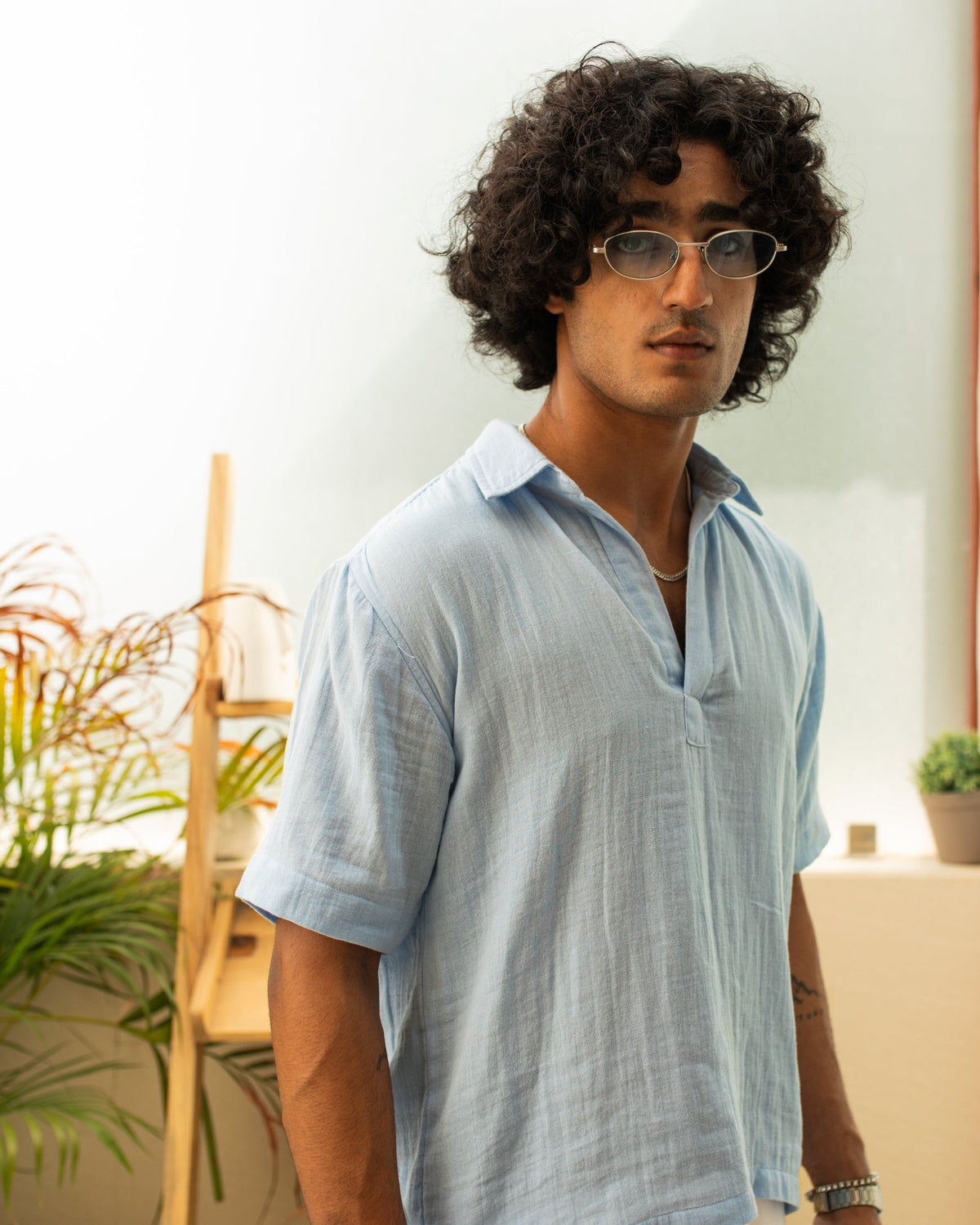 Light blue short-sleeve button-up shirt with pointed collar and chest seam detail