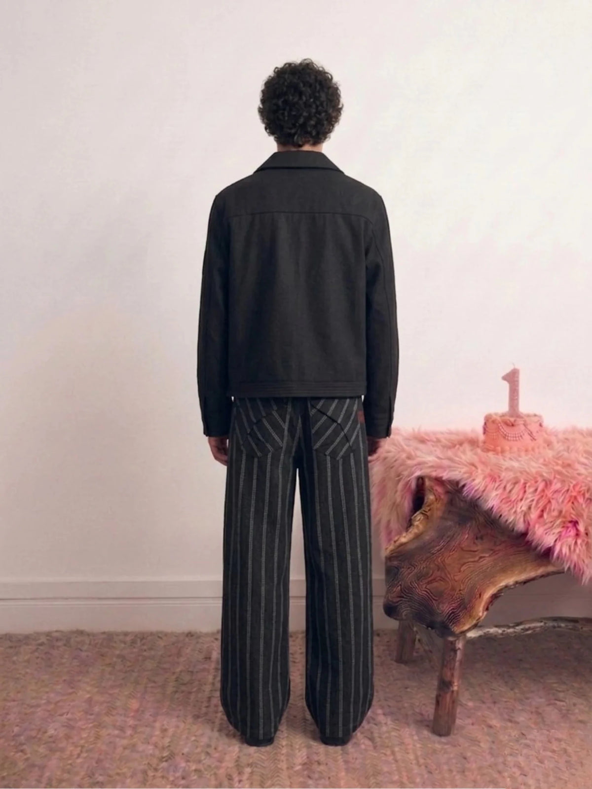 Black pinstripe jacket from back with long sleeves and stand collar