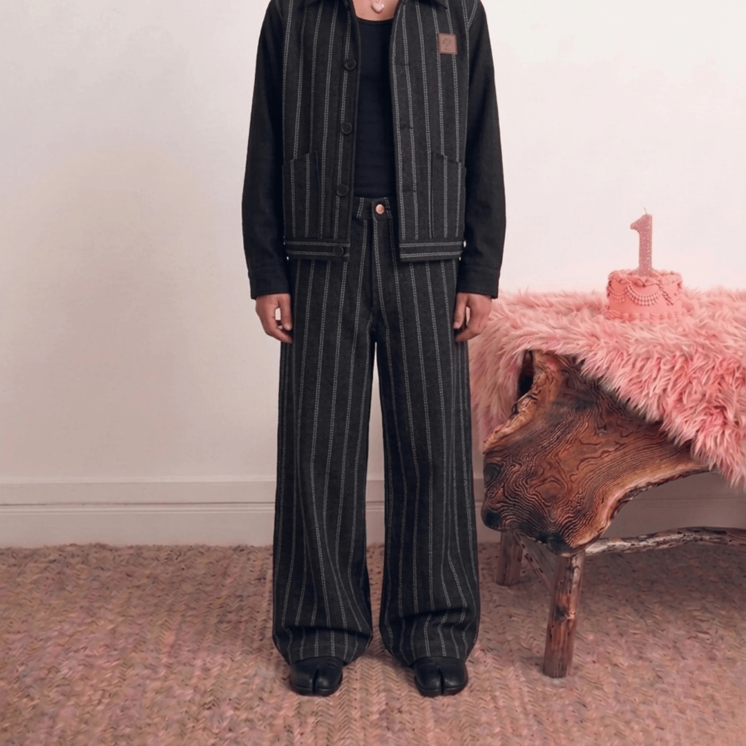 Wide-leg dark pinstripe pants with straight waistband and side pockets