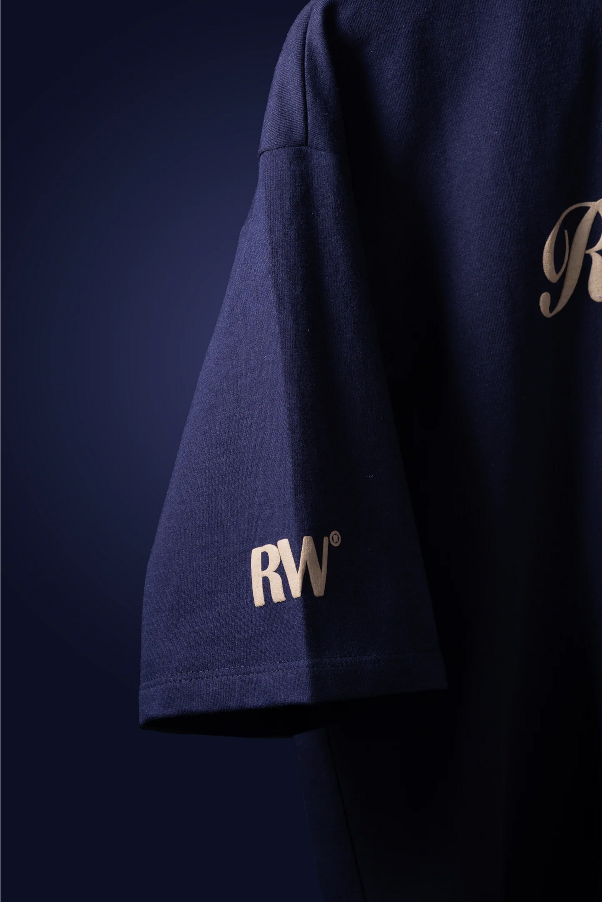 Dark navy T-shirt sleeve with small RW patch logo