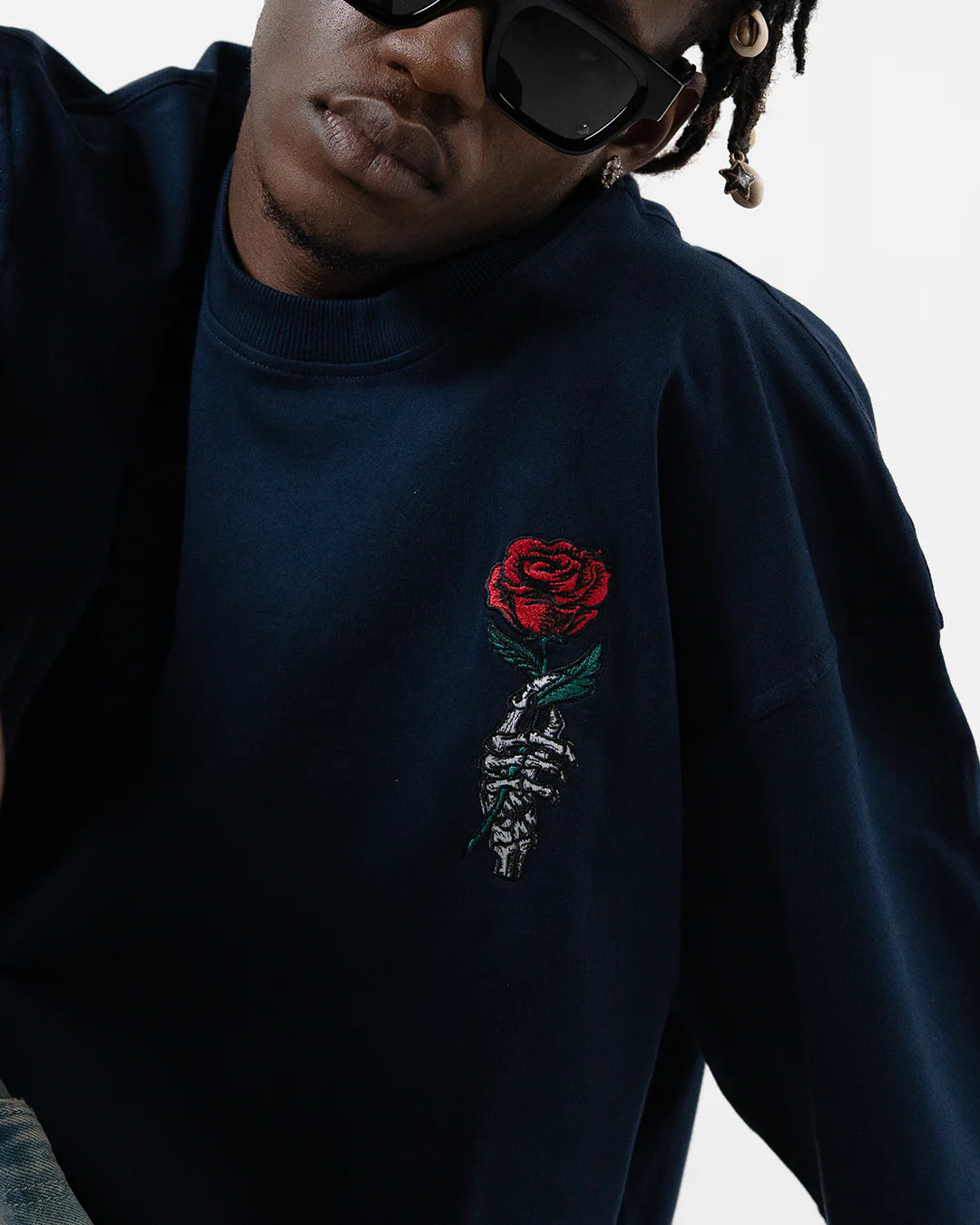 Rose and skeleton embroidery on dark blue crew-neck T-shirt chest
