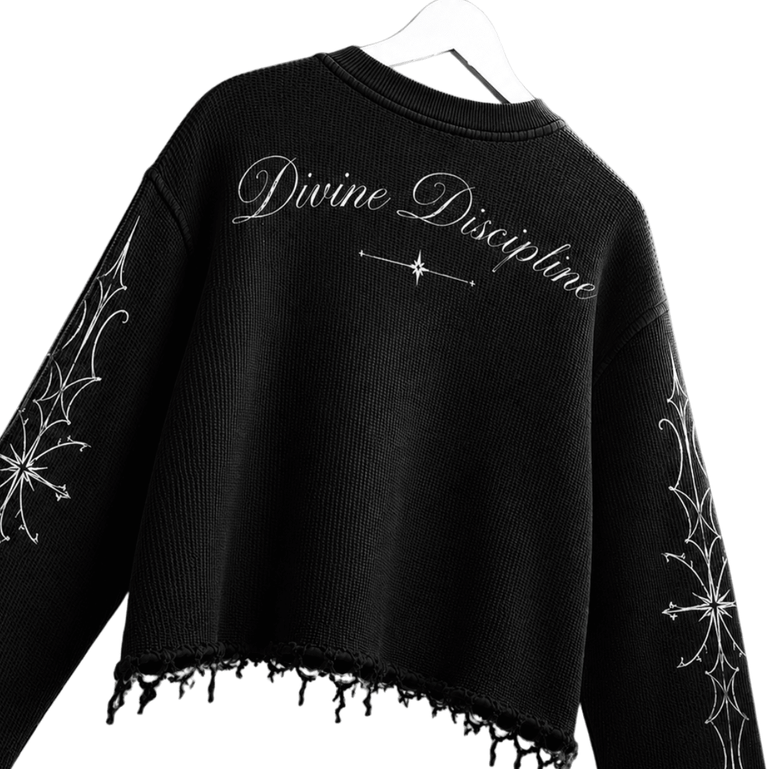 Black waffle-knit sweatshirt with “Divine Discipline” script and small star graphic