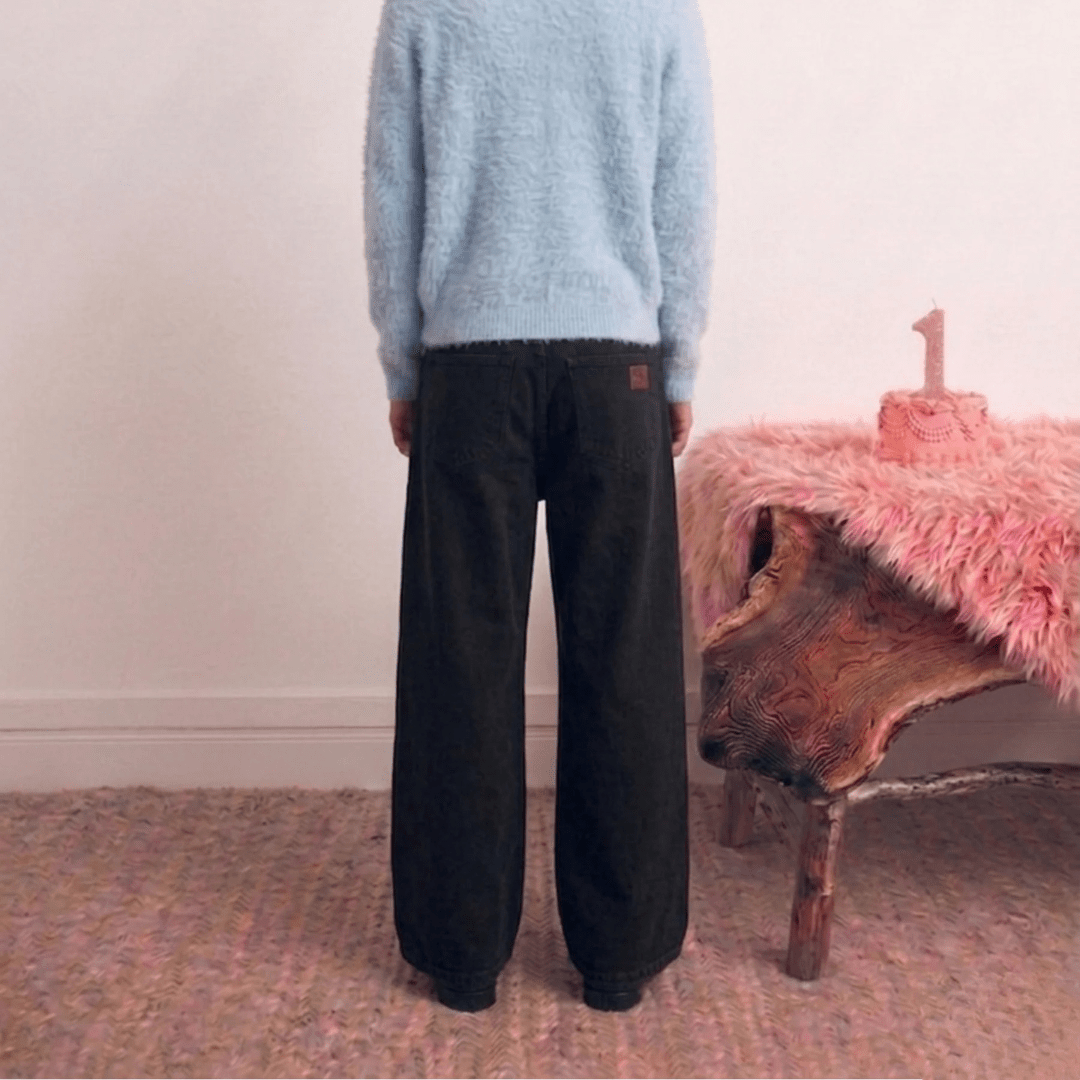 Black denim wide-leg jeans with waistband buttons and straight wide legs