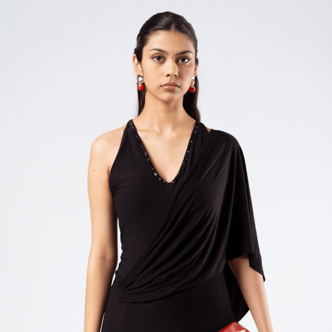 Black drape gown with V-neck sleeveless silhouette and studded trim at neckline