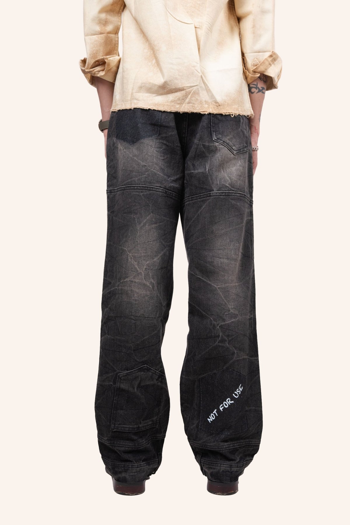 Dark utility denim jogger jeans with cuffed hem and embroidered side text