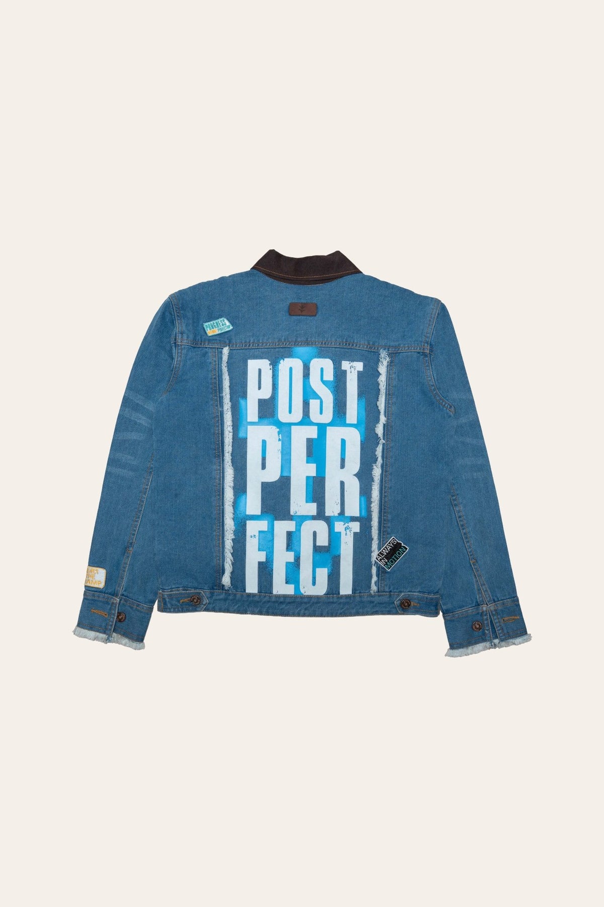 Blue denim jacket back panel featuring POST PER FECT text graphic.