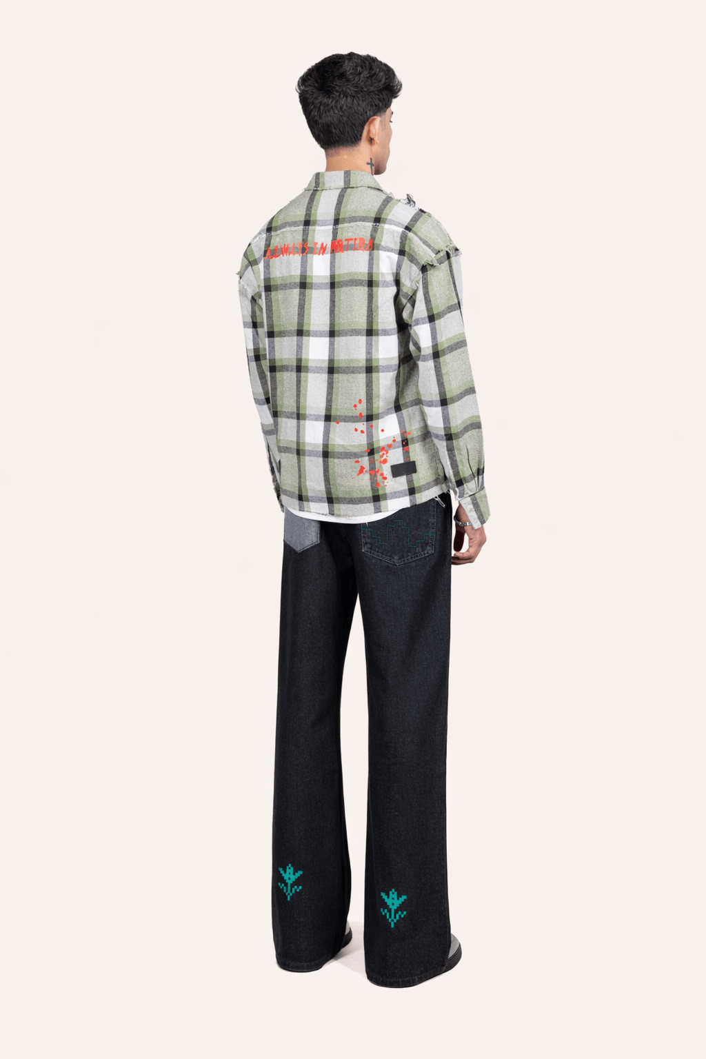 Black denim jeans, back view with wide legs and green embroidered motifs
