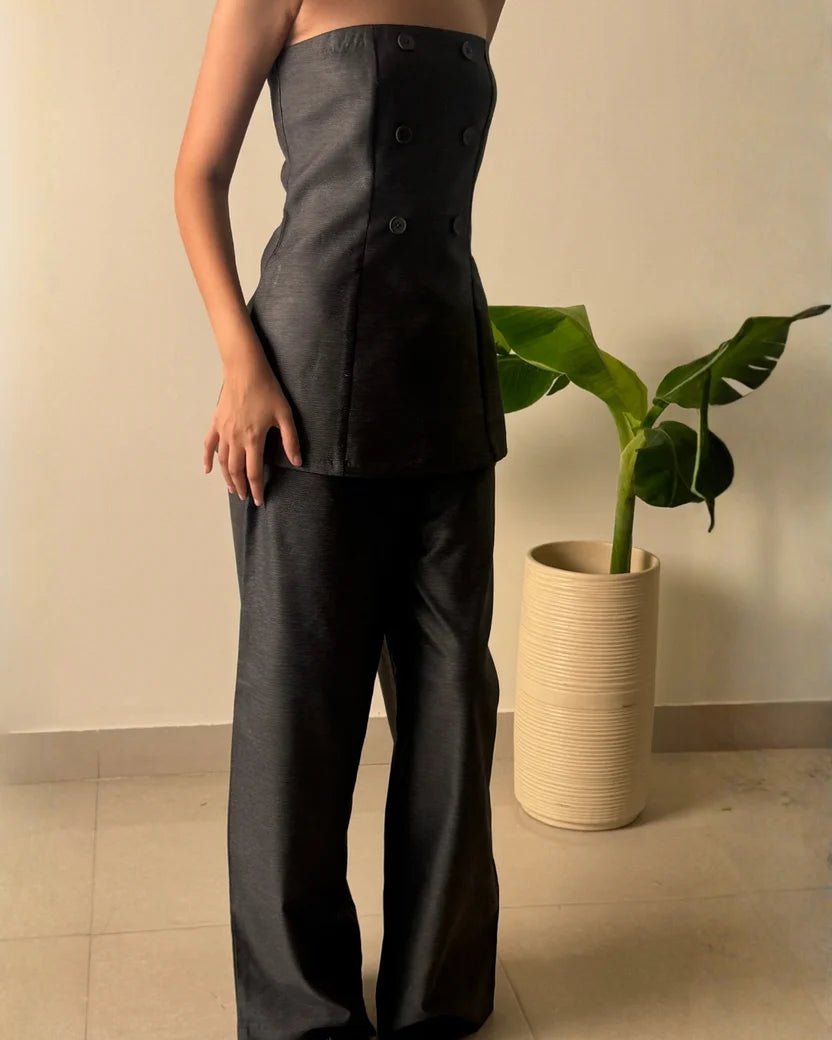 Charcoal strapless fitted top with buttons and matching wide-leg trousers, side view