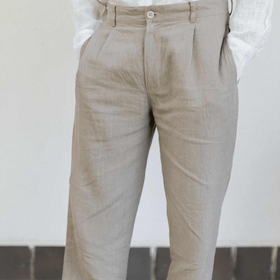 Ecru embroidered trousers close-up, button waist, front pockets and belt loops