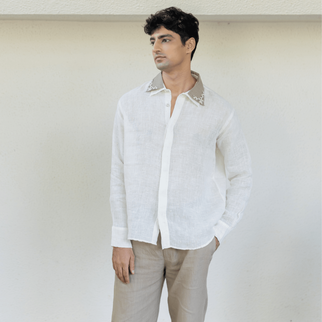 Ecru embroidered trousers worn by model, straight fit with stitched hem detail