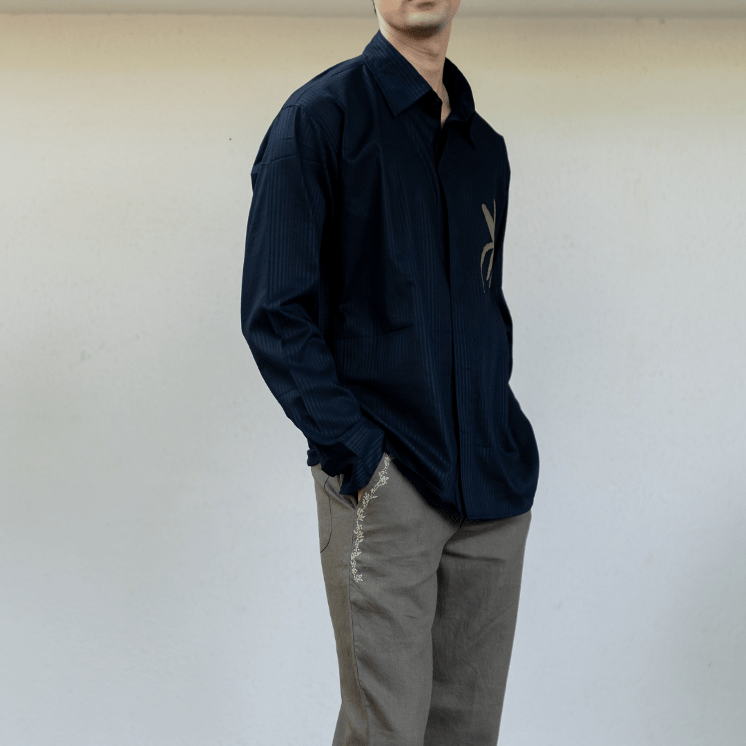 Dark navy striped button-up shirt with long sleeves and gold flower applique on chest