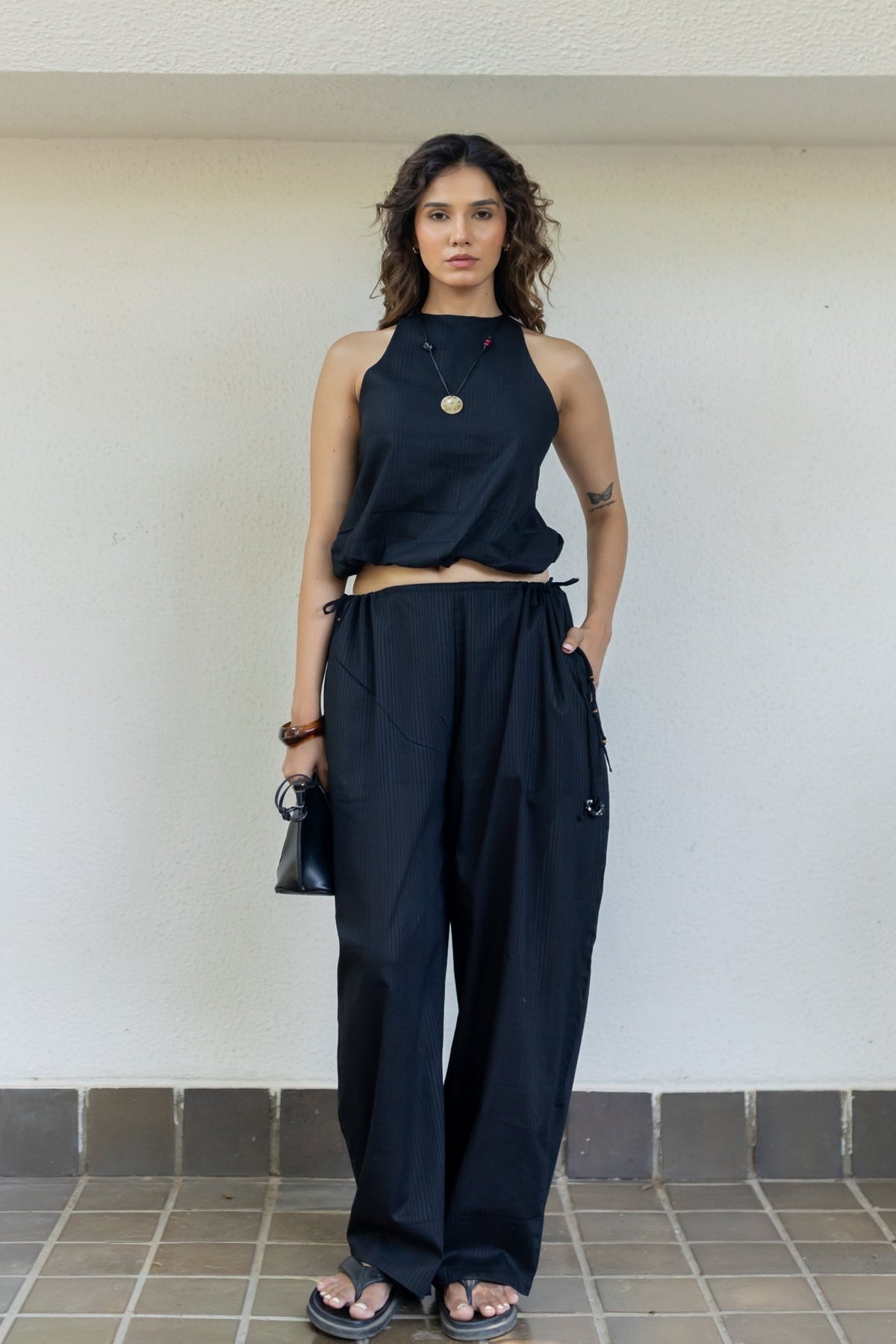 Sleeveless dark top and wide-leg pants co-ord set with tie waist, front view